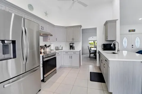 a kitchen with a sink stove and refrigerator