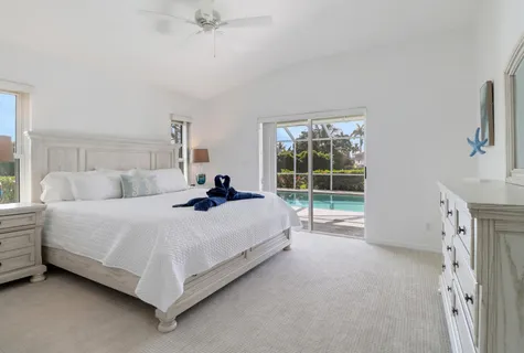 a spacious bedroom with a bed and a window