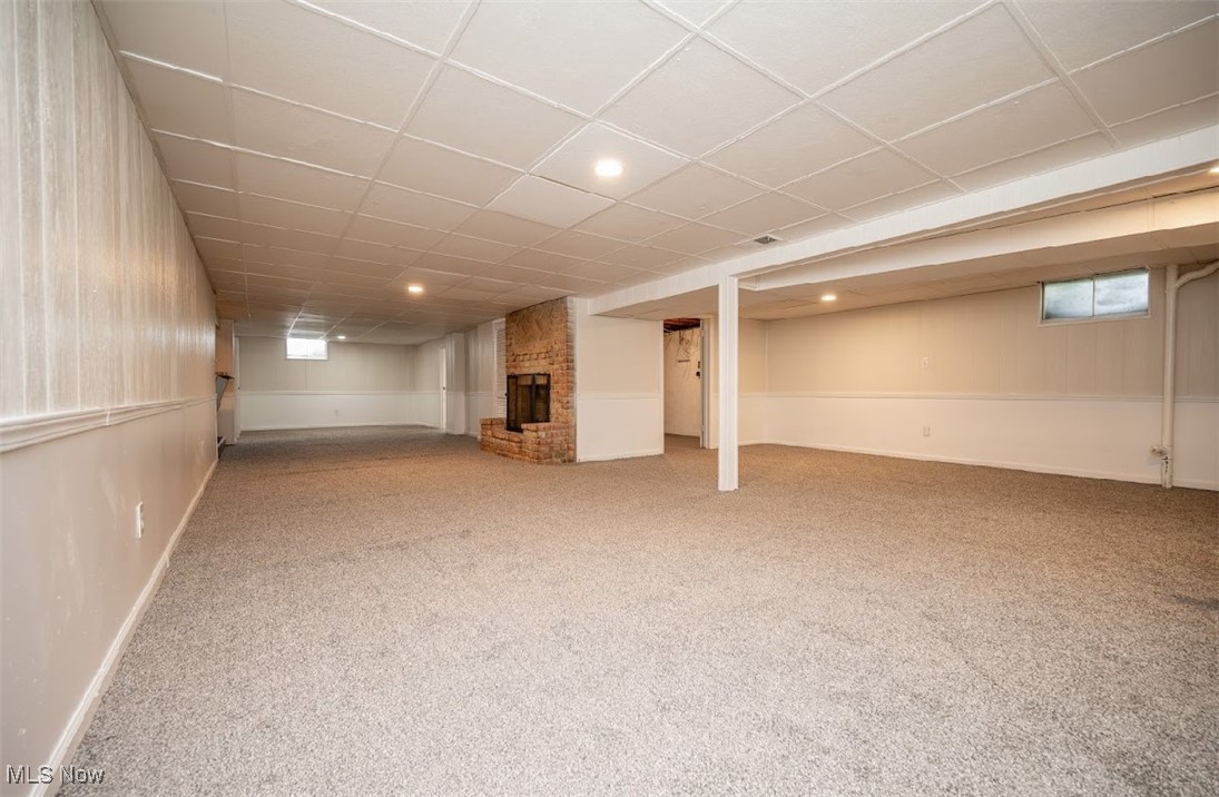 6006 Tippecanoe Road Canfield, OH 44406 - Photo 24 of 35 Basement with carpet flooring, a fireplace, a drop ceiling, baseboards, and recessed lighting