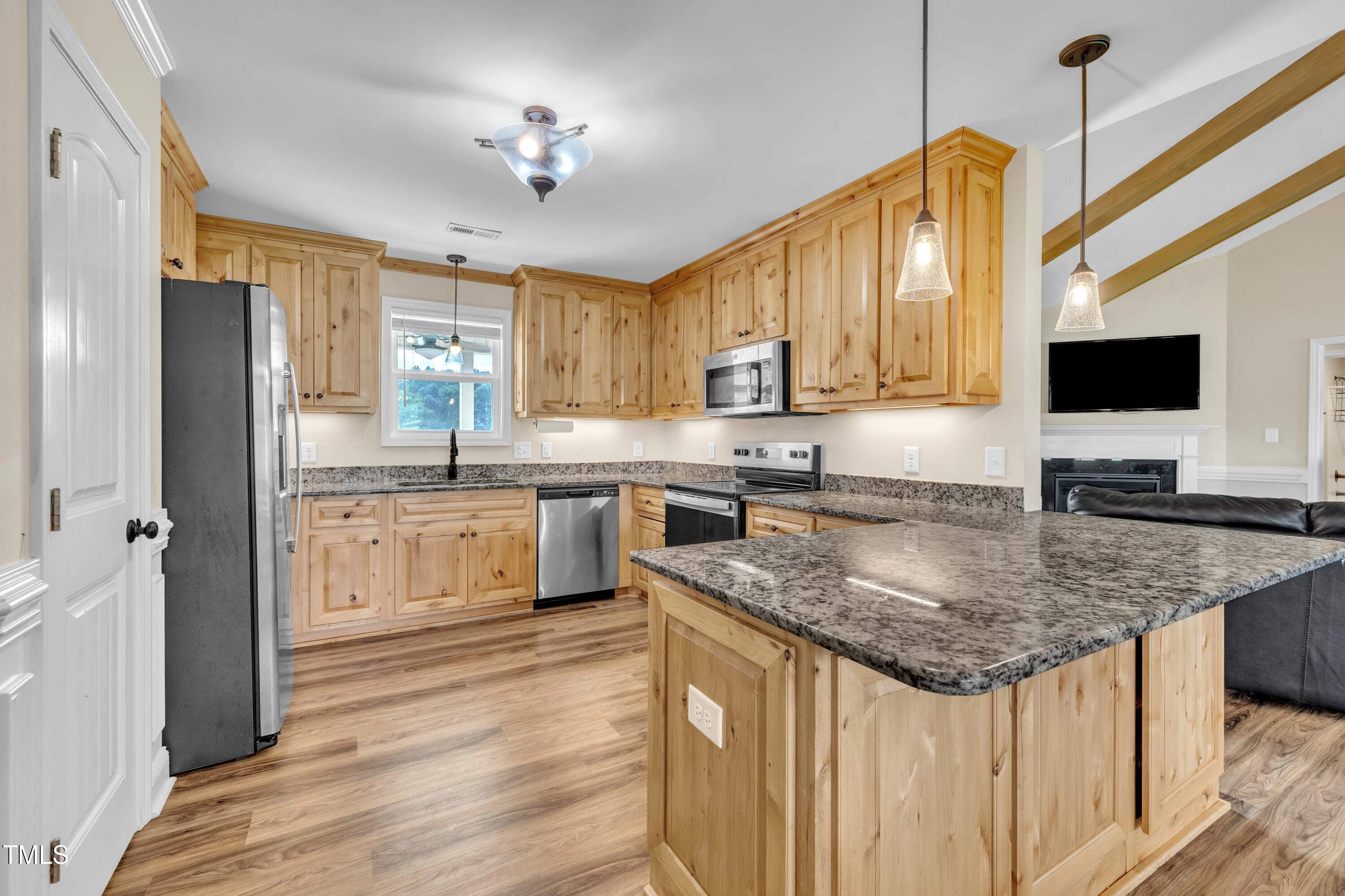 1149 Surles Road Benson, NC 27504 - Photo 2 of 29 a kitchen with stainless steel appliances granite countertop a sink stove and refrigerator