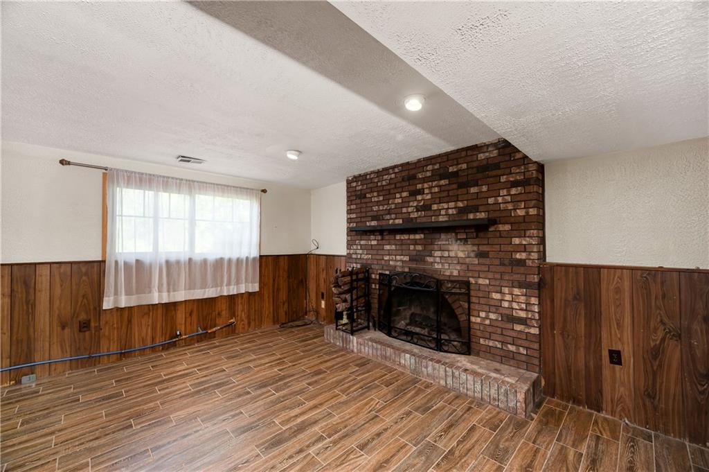 201 Colleen Street Butler, PA 16001 - Photo 30 of 33 an empty room with wooden floor fireplace and windows