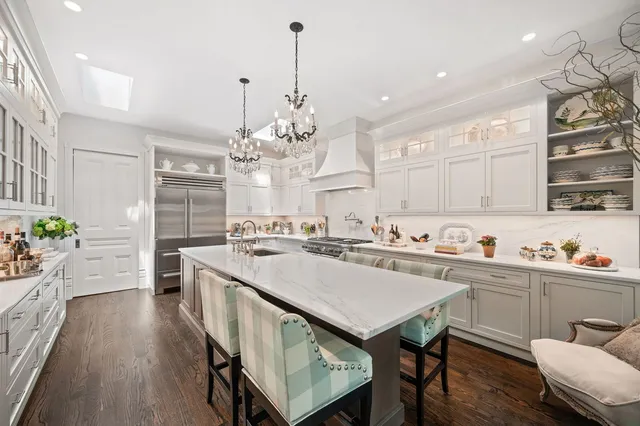 a kitchen with sink a stove and chairs