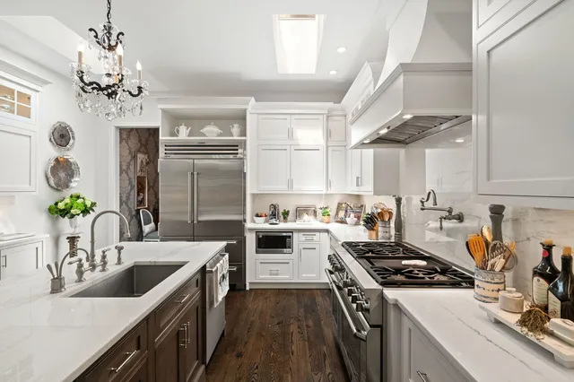 a kitchen with a stove sink and refrigerator