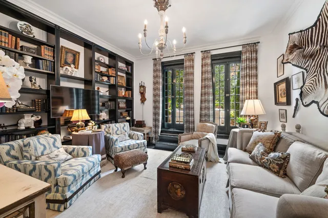 a living room with furniture a large window and a flat screen tv