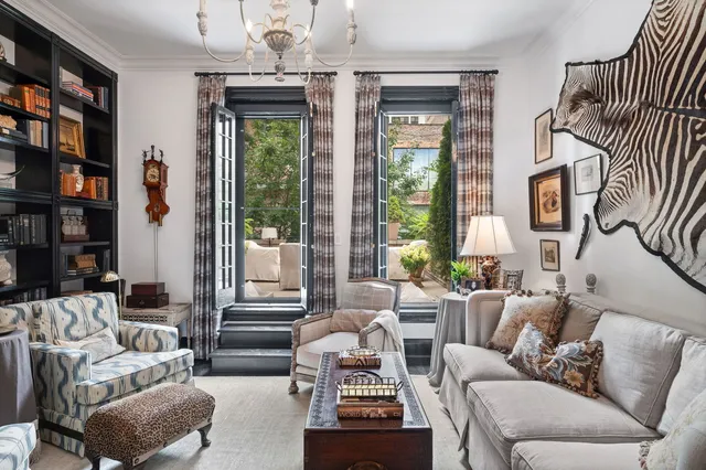 a living room with furniture a window and a chandelier