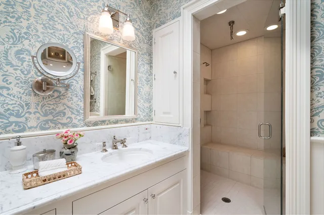 a bathroom with a sink a mirror and a shower