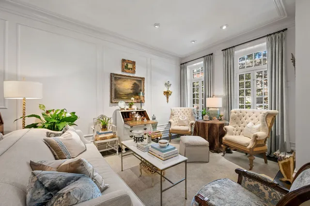 a living room with furniture potted plant and a large window