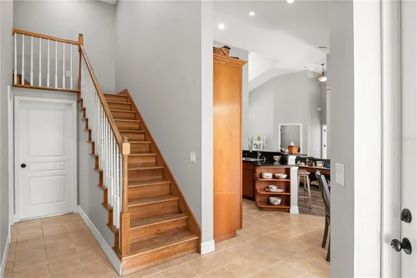 an empty room with wooden floor and fan