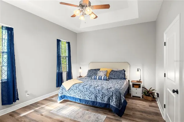 a bedroom with a bed and wooden floor
