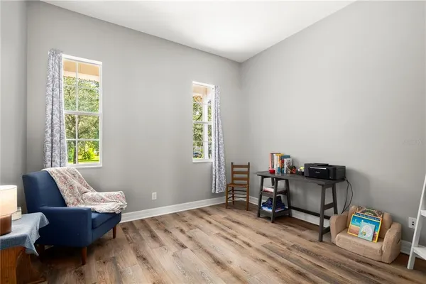 a living room with furniture and a lamp