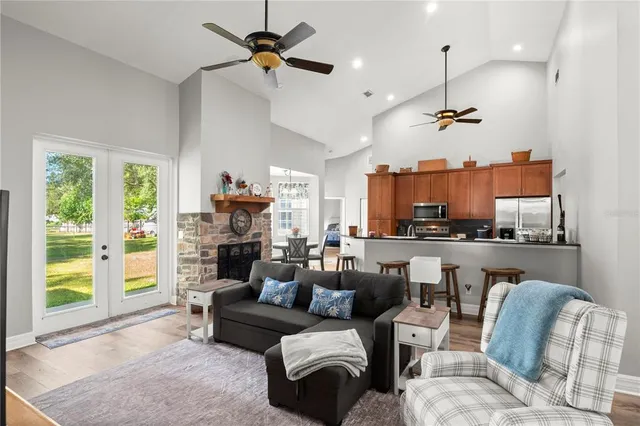 a living room with furniture and kitchen view