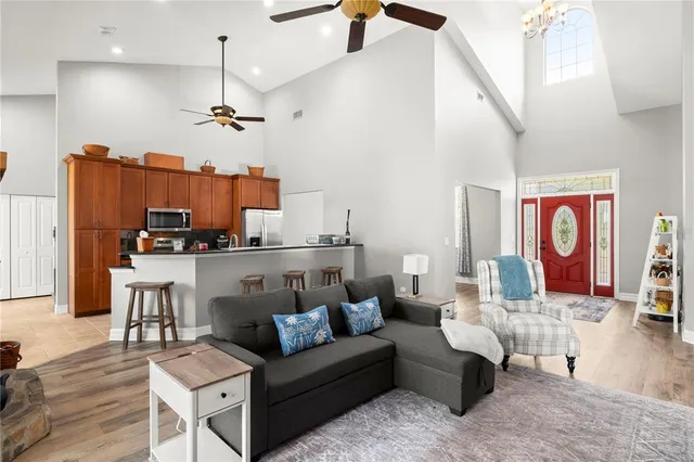 a living room with furniture a fireplace and a floor to ceiling window