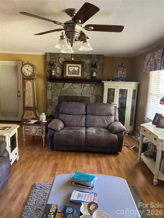 a living room with fireplace furniture and a flat screen tv
