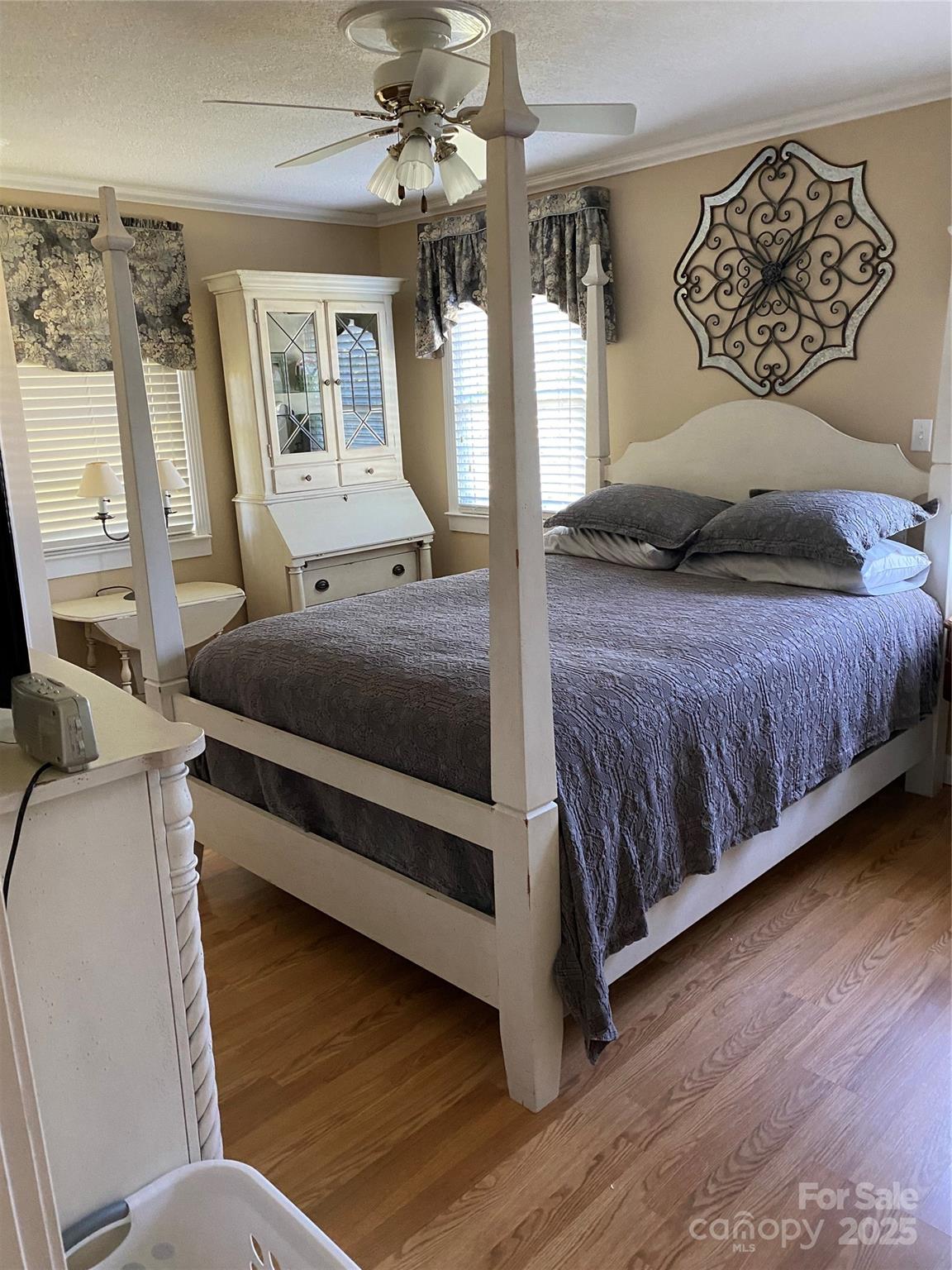 9525 Mull Road Vale, NC 28168 - Photo 18 of 36 a bedroom with a large bed chandelier and a window