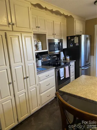 a view of a kitchen with a sink and cabinets