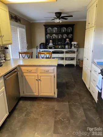 a view of a kitchen with dining table and chairs