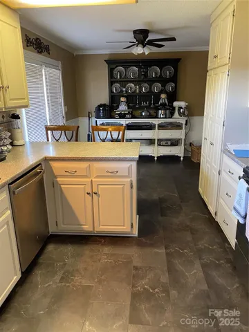 a view of a kitchen with dining table and chairs