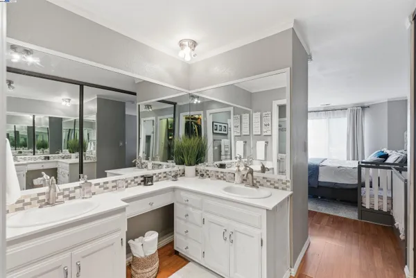 a bathroom with a double vanity sink mirror and