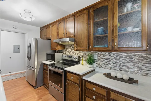 a kitchen with stainless steel appliances a sink stove and refrigerator
