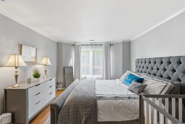 a bedroom with furniture and a large window