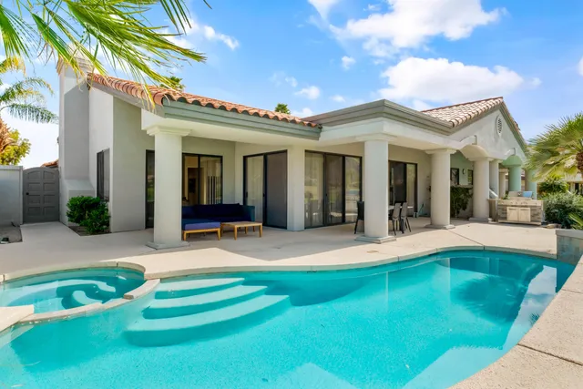a view of a house with swimming pool and sitting area