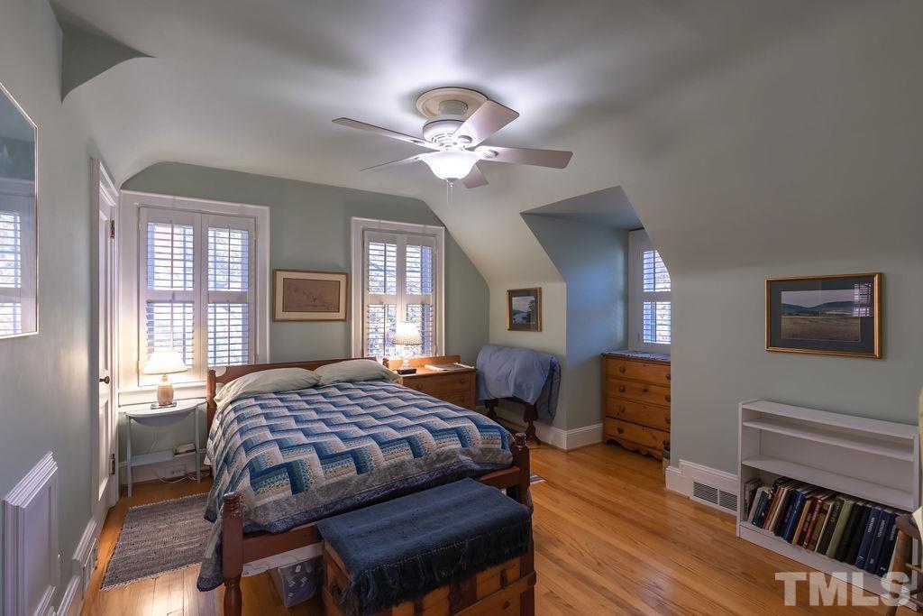 3203 Bedford Avenue Raleigh, NC 27607 - Photo 12 of 20 a bedroom with a bed and a chandelier