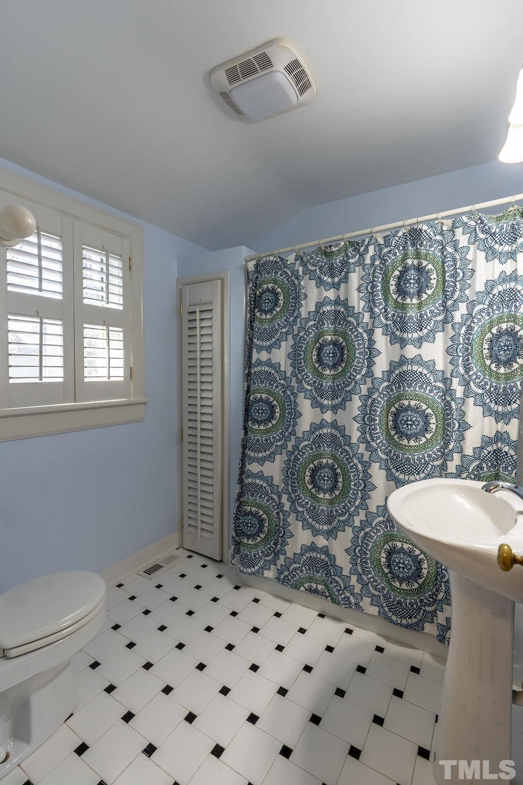 3203 Bedford Avenue Raleigh, NC 27607 - Photo 13 of 20 a bathroom with a toilet sink and mirror