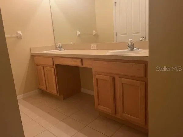 a white toilet sitting next to a sink