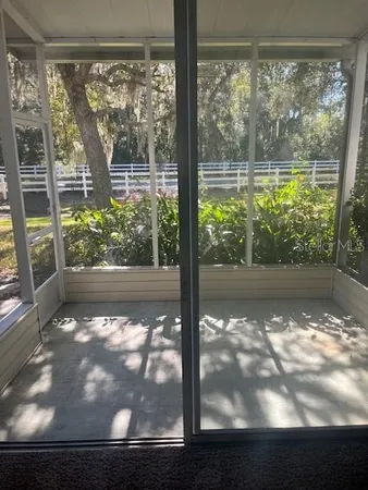 an aerial view of a house with swimming pool and sitting space