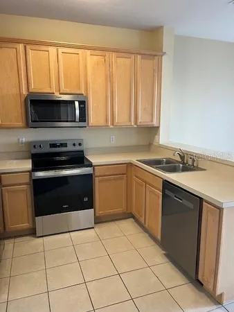 a kitchen with a stove a sink and a microwave