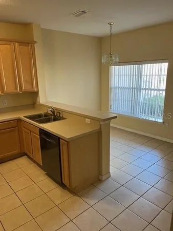 a kitchen that has a sink and a stove
