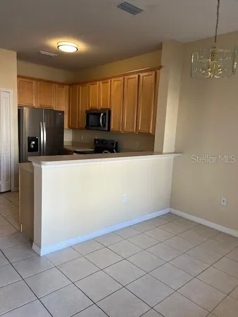 a kitchen with granite countertop white cabinets and stainless steel appliances