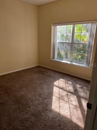 an empty room with a door and a bathroom