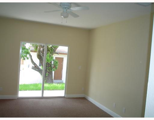 910 Phippen Waiters Road Dania Beach, FL 33004 - Photo 12 of 16 a view of an empty room and window