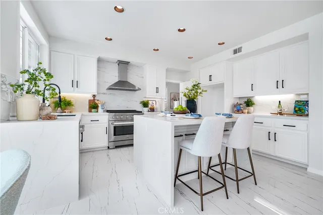 a dining room with furniture a potted plant and a chandelier