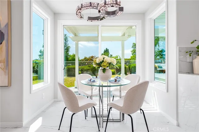 a living room with furniture a fireplace and a large window