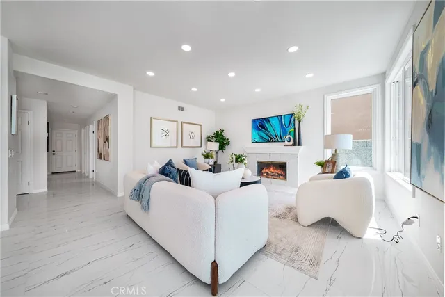 a living room with furniture and a potted plant