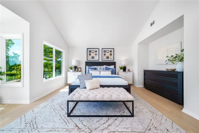a spacious bathroom with a double vanity sink a bathtub and next to a window