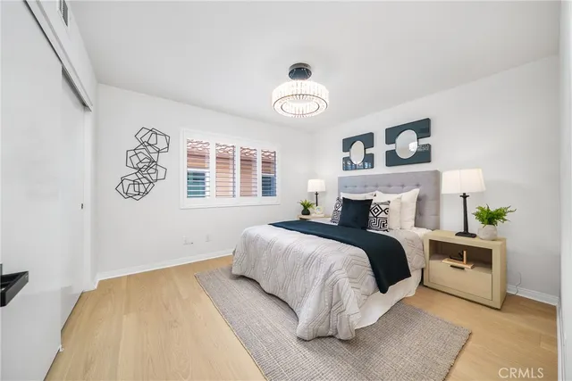 a bedroom with a bed window and table