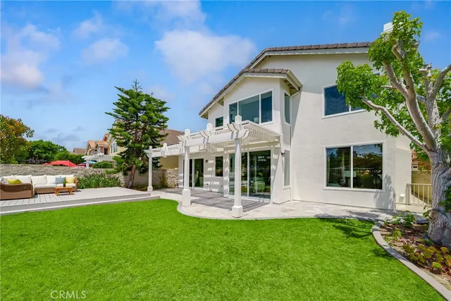 a view of house with swimming pool and yard