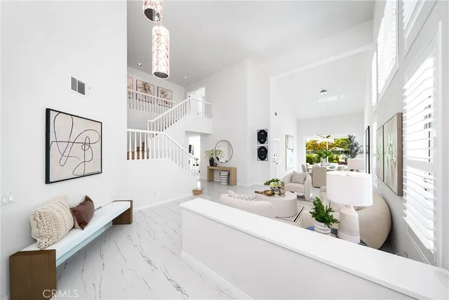 a living room with furniture and floor to ceiling windows