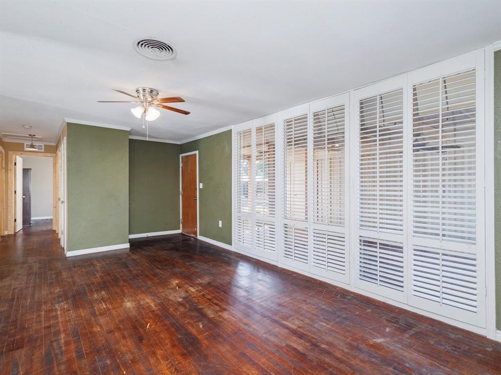 311 Miami Street Coleman, TX 76834 - Photo 12 of 31 a view of an empty room with a window and wooden floor