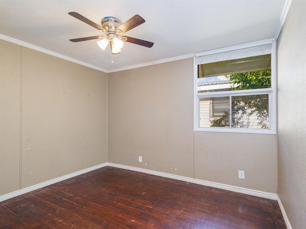 311 Miami Street Coleman, TX 76834 - Photo 16 of 31 a view of an empty room with window and wooden floor