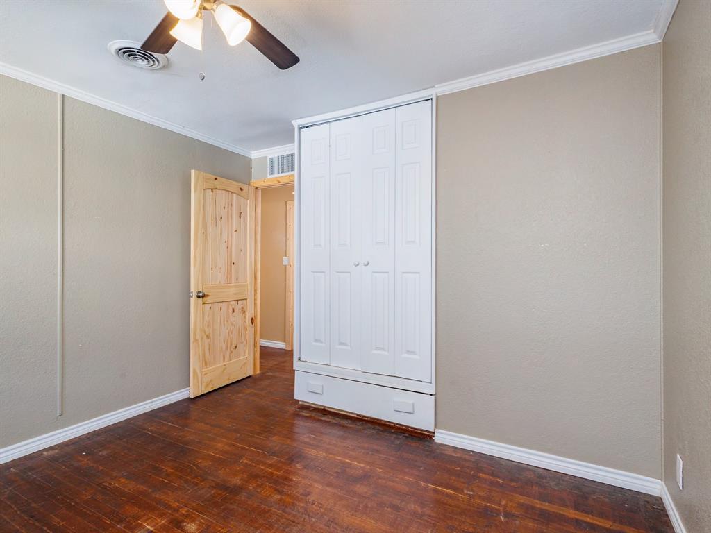 311 Miami Street Coleman, TX 76834 - Photo 17 of 31 an empty room with wooden floor closet and windows