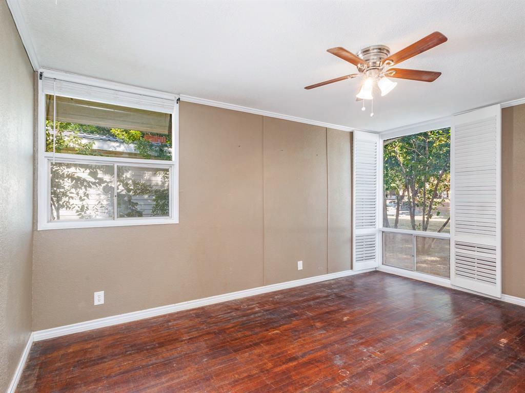 311 Miami Street Coleman, TX 76834 - Photo 20 of 31 an empty room with wooden floor fan and windows