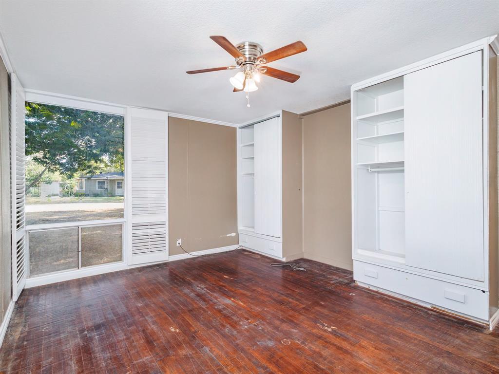 311 Miami Street Coleman, TX 76834 - Photo 21 of 31 wooden floor in an empty room with a window