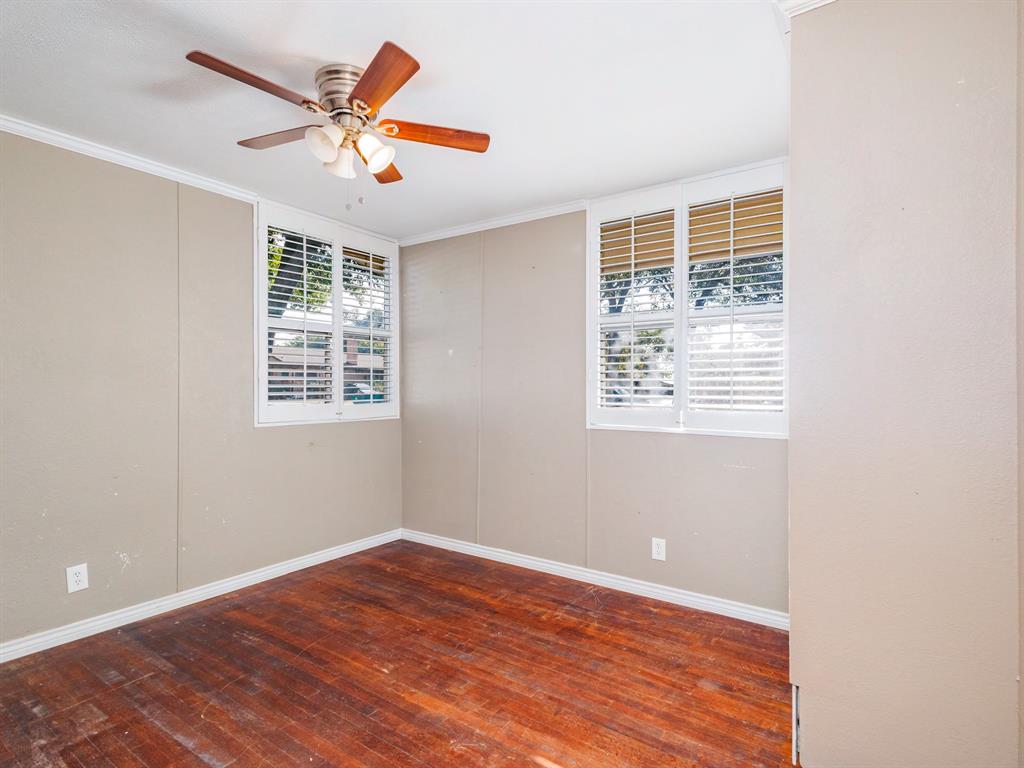 311 Miami Street Coleman, TX 76834 - Photo 22 of 31 a view of an empty room with wooden floor and a window
