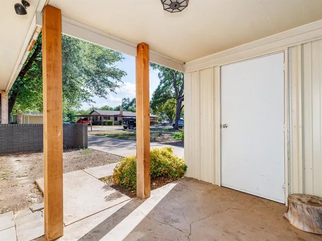 a porch with a bench in front of it