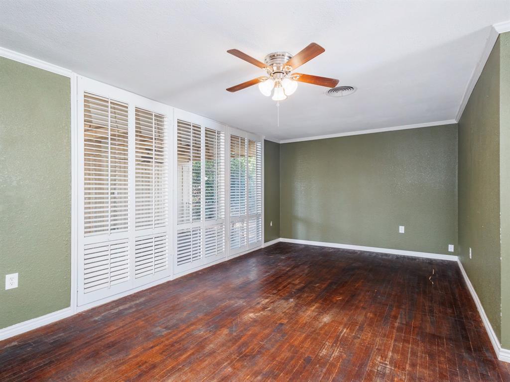 311 Miami Street Coleman, TX 76834 - Photo 7 of 31 a view of an empty room with wooden floor and a window