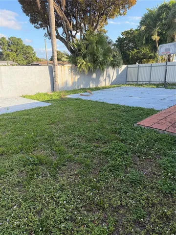 a view of yard with swimming pool and green space